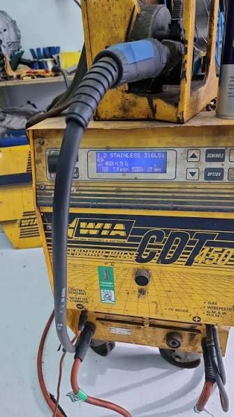 Digital display on a WIA CDT wire feeder reading 1.2 STAINLESS 316LSI and 5.0 metres per minute